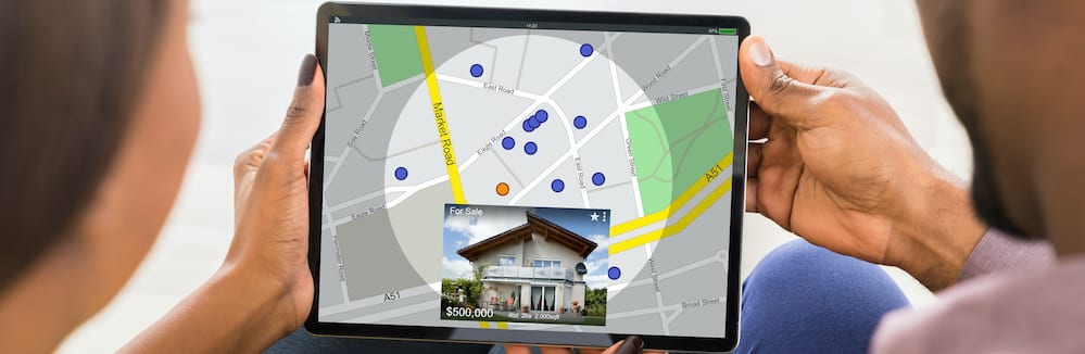 Couple using tablet to find property